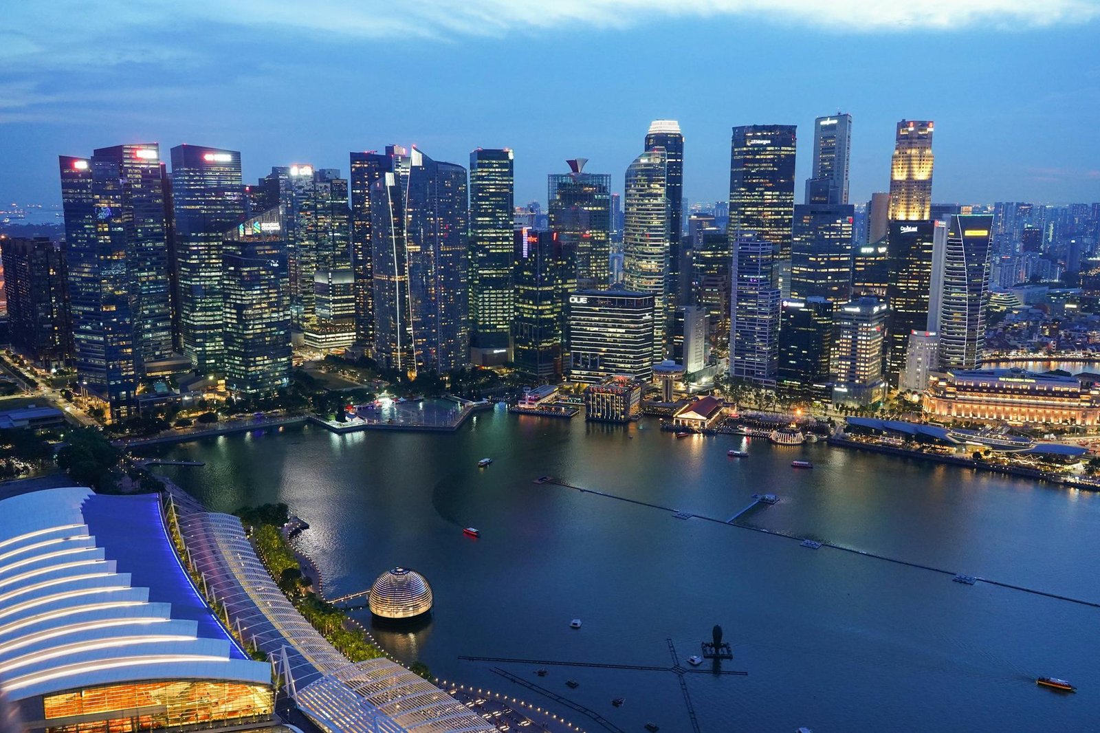 Marina Bay and Singapore's skyline at dusk, seen from above